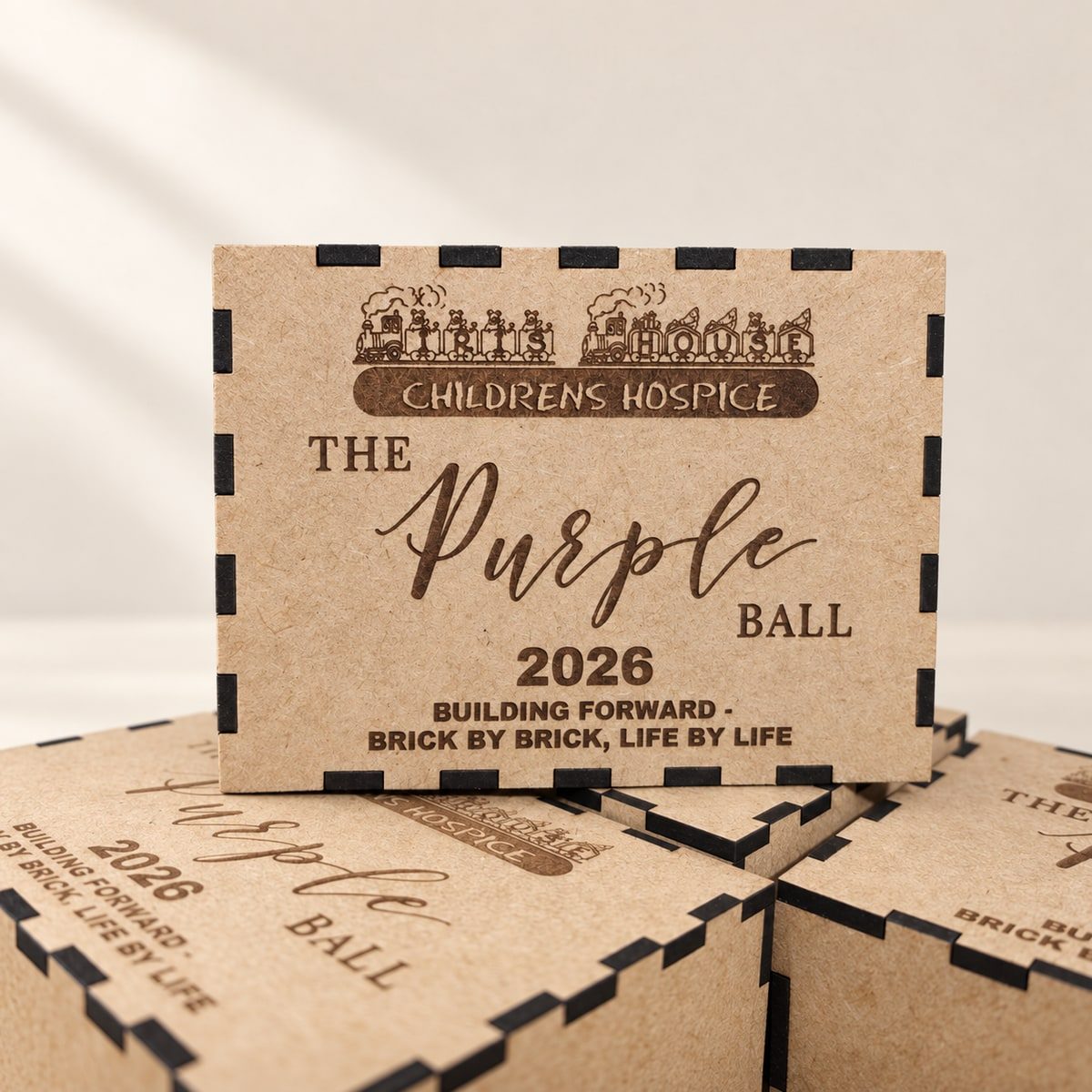 Wooden keepsake boxes engraved for the Iris House Purple Ball 2026.