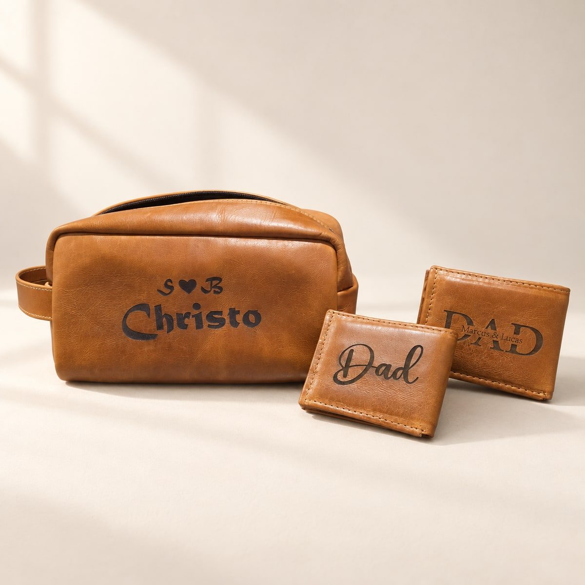 Personalised Christo leather bag alongside two engraved Dad wallets.